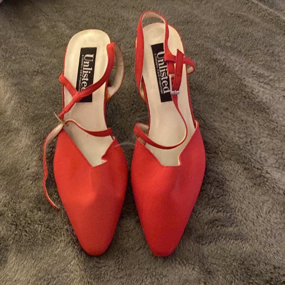 Red strapped dress shoe.